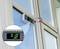 A digital protractor displays '0.10°' and is mounted on a window frame to measure the window's inclination.