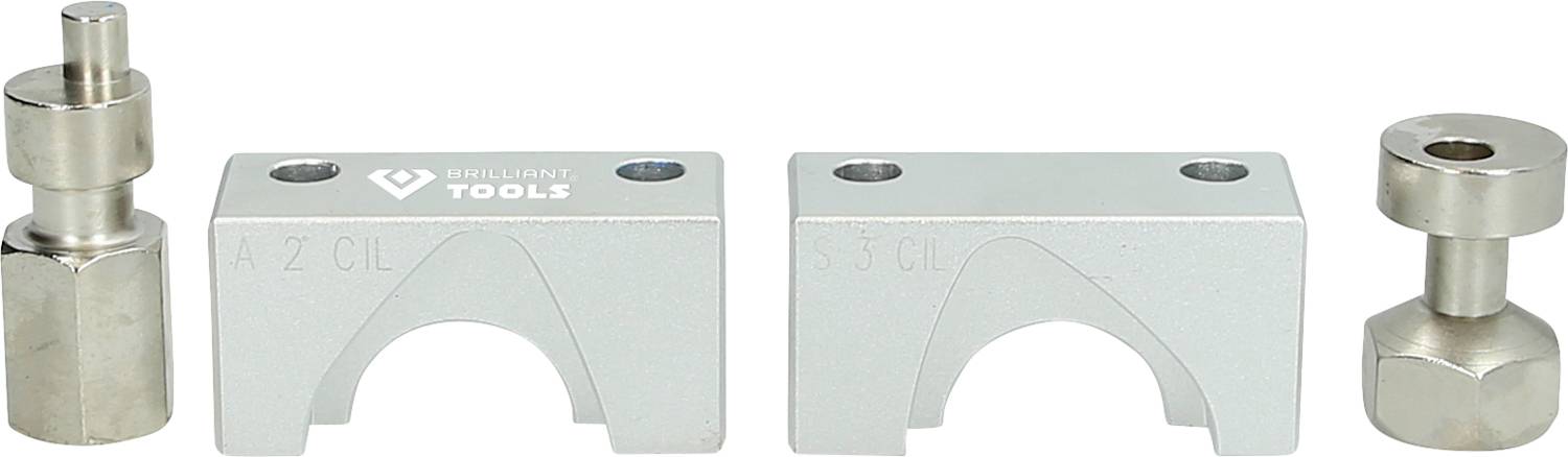 Four metallic car tools, consisting of two clamps and two pins, on a white surface.