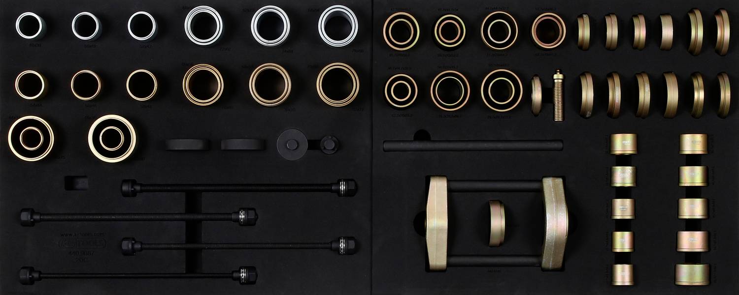 A selection of metal rings and washers in various sizes and materials, arranged in rows against a black background.