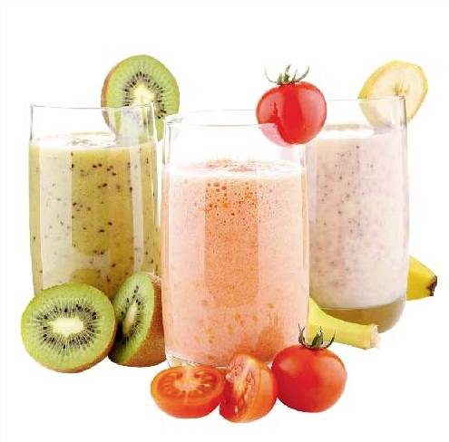 Three glasses of smoothies, flanked by kiwis, tomatoes, and bananas. Each smoothie has a different colour, matching the fruits.