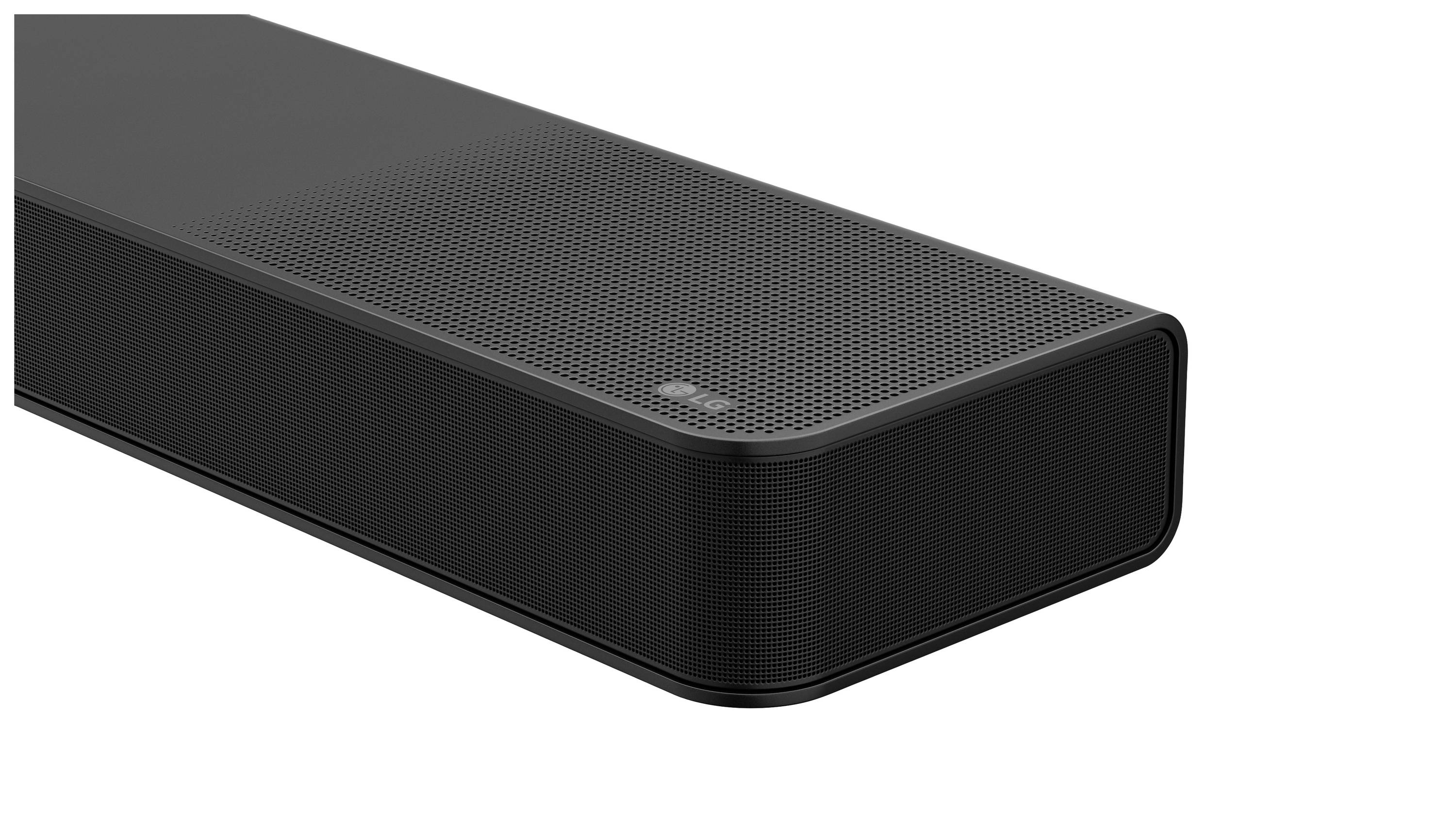 Black soundbar with a simple, modern design, rectangular with rounded corners. A fine mesh pattern is located on the top.