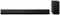 Black soundbar and vertical subwoofer side by side, showing a modern audio set for enhanced sound in home cinema systems.