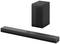 A black soundbar with subwoofer. The soundbar is long and narrow, the subwoofer is rectangular. Both are standing on a white background.