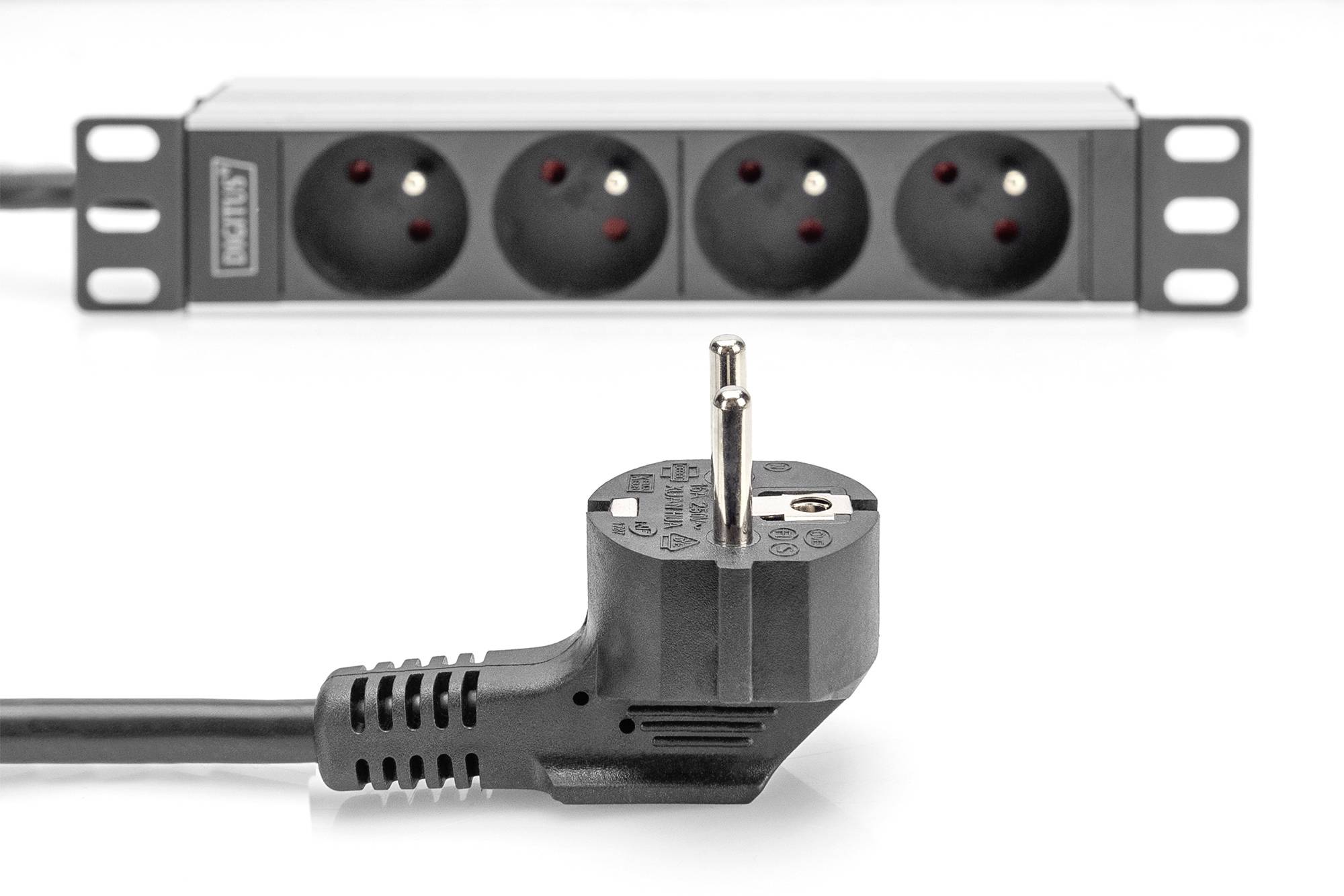 A black multi-socket extension with four sockets and an unplugged plug in the foreground.