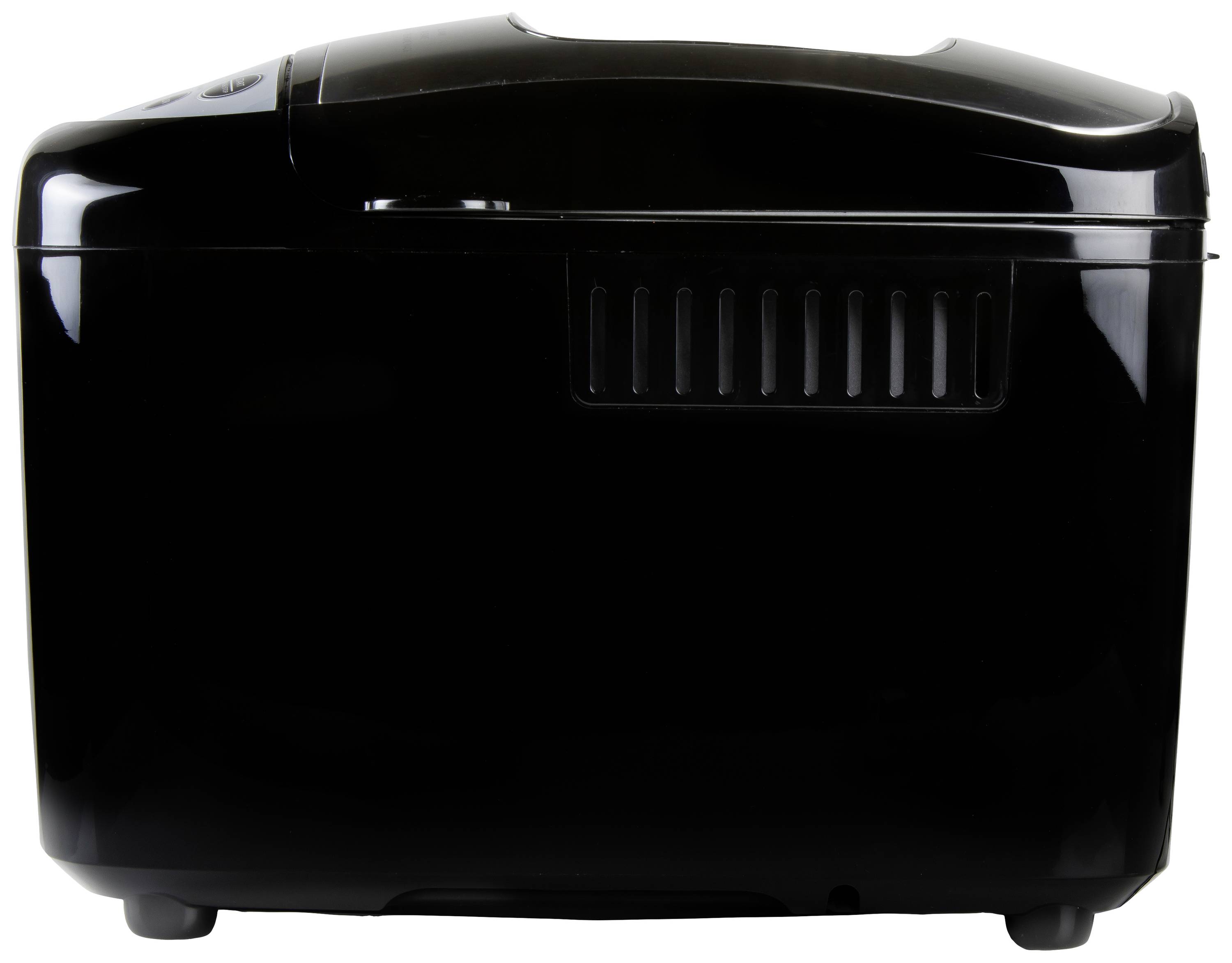 Black bread maker with rounded casing, ventilation slots and flat lid, side view.