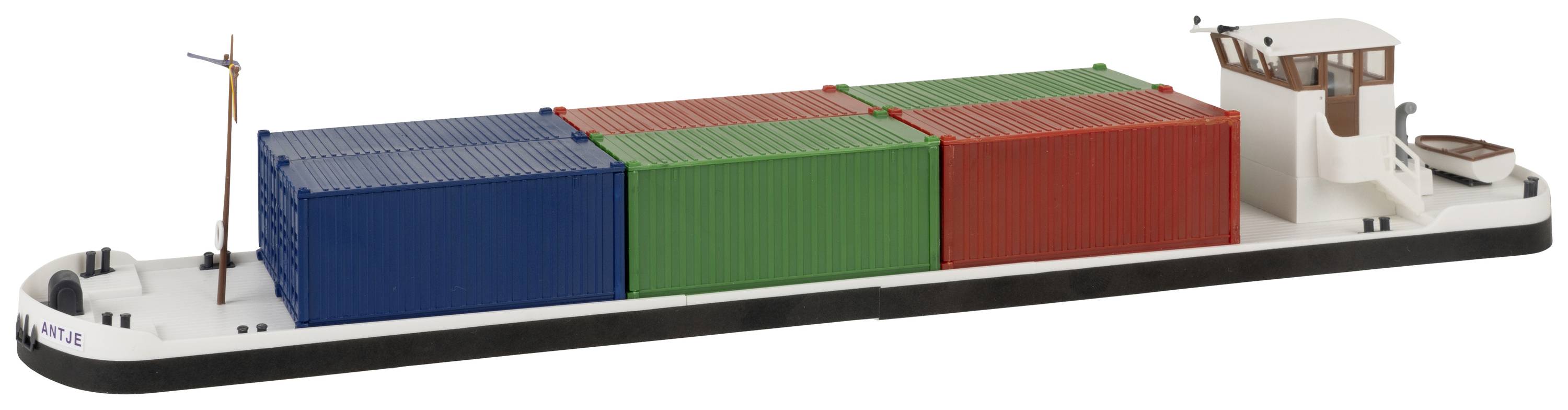 A cargo ship with six coloured containers on deck, arranged in rows of blue, red and green, sailing on a waterway. Primary focus on cargo.
