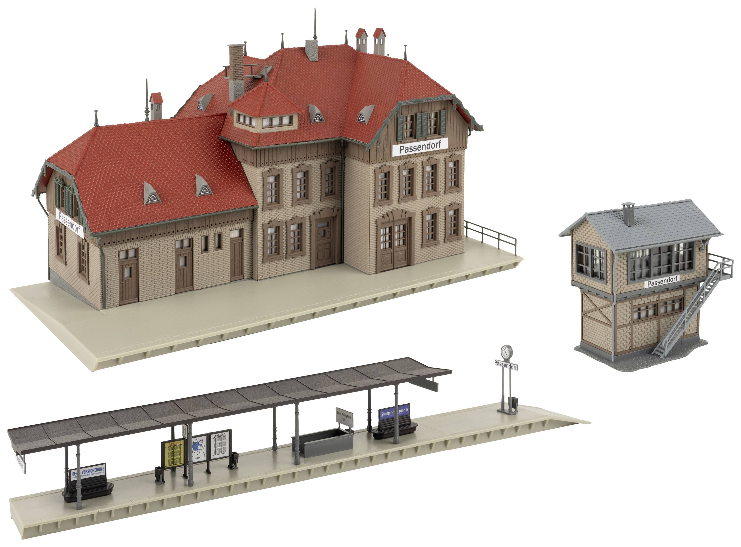 Model of a small railway station with main building, platform with waiting area and a separate signal box.