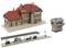 Model of a small railway station with main building, platform with waiting area and a separate signal box.
