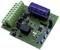 A green printed circuit board with various electronic components, including a large blue capacitor and several connectors.