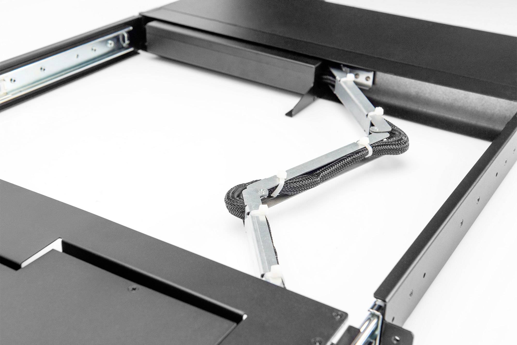 A black metal-framed piece with movable hinges and cable strands, potentially part of a piece of furniture or a mounting bracket.