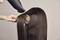 A person is blow-drying long, smooth brown hair with a round brush.