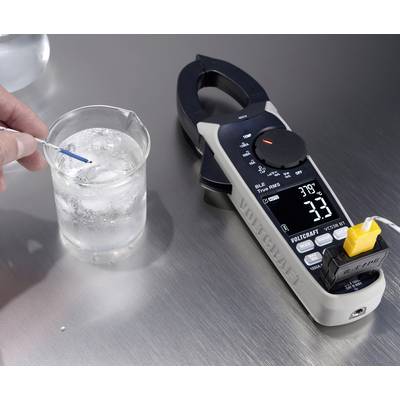 A hand is measuring the water temperature in a beaker using a digital thermometer, which displays 3.8°C.