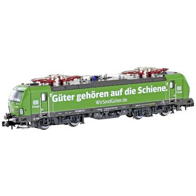 Green freight train from DB Cargo with the inscription 'Freight belongs on the railway'. Transporting cargo on railway tracks.