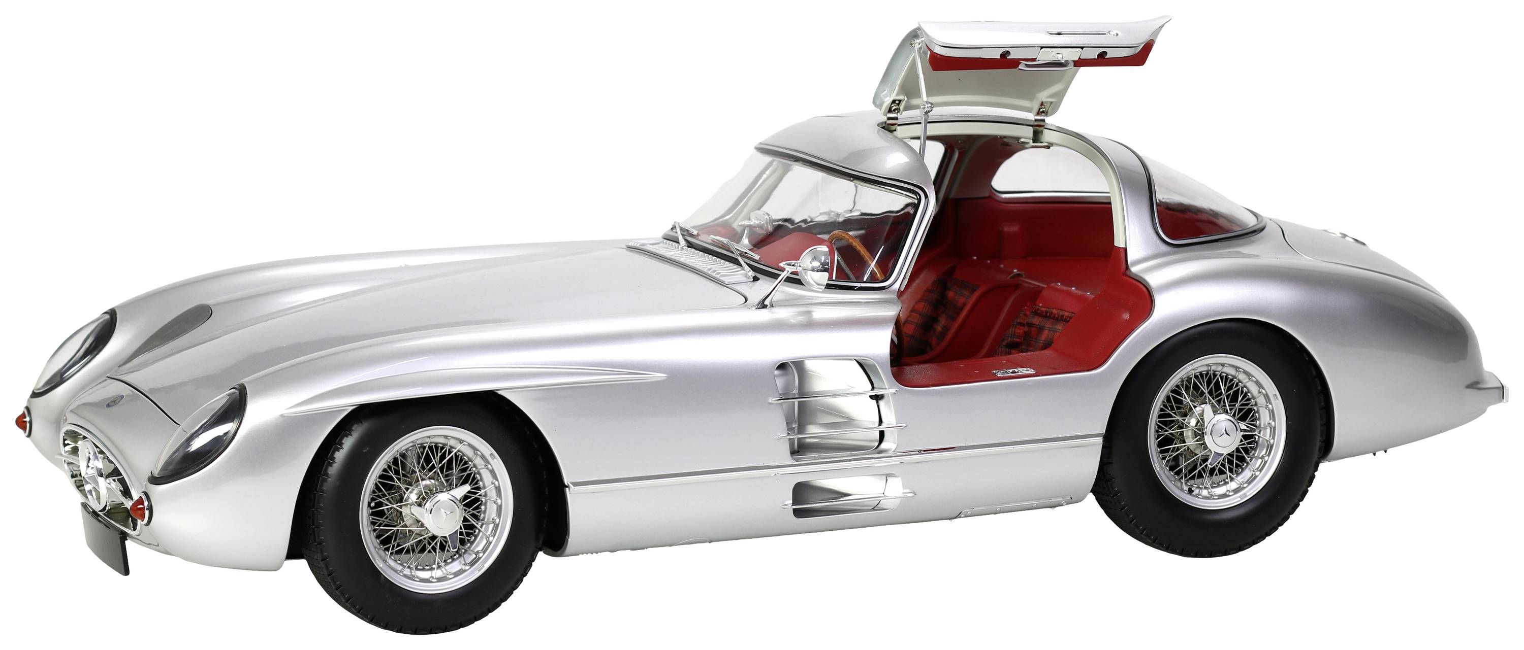 A silver, classic sports car with gull-wing doors and red seats, photographed in photorealistic detail in a studio.
