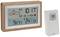 Digital thermometer with wooden frame showing weather data: Sun, air pressure, temperature indoors '24.1°C', outdoors '9.8°C'. Wireless sensor beside it.