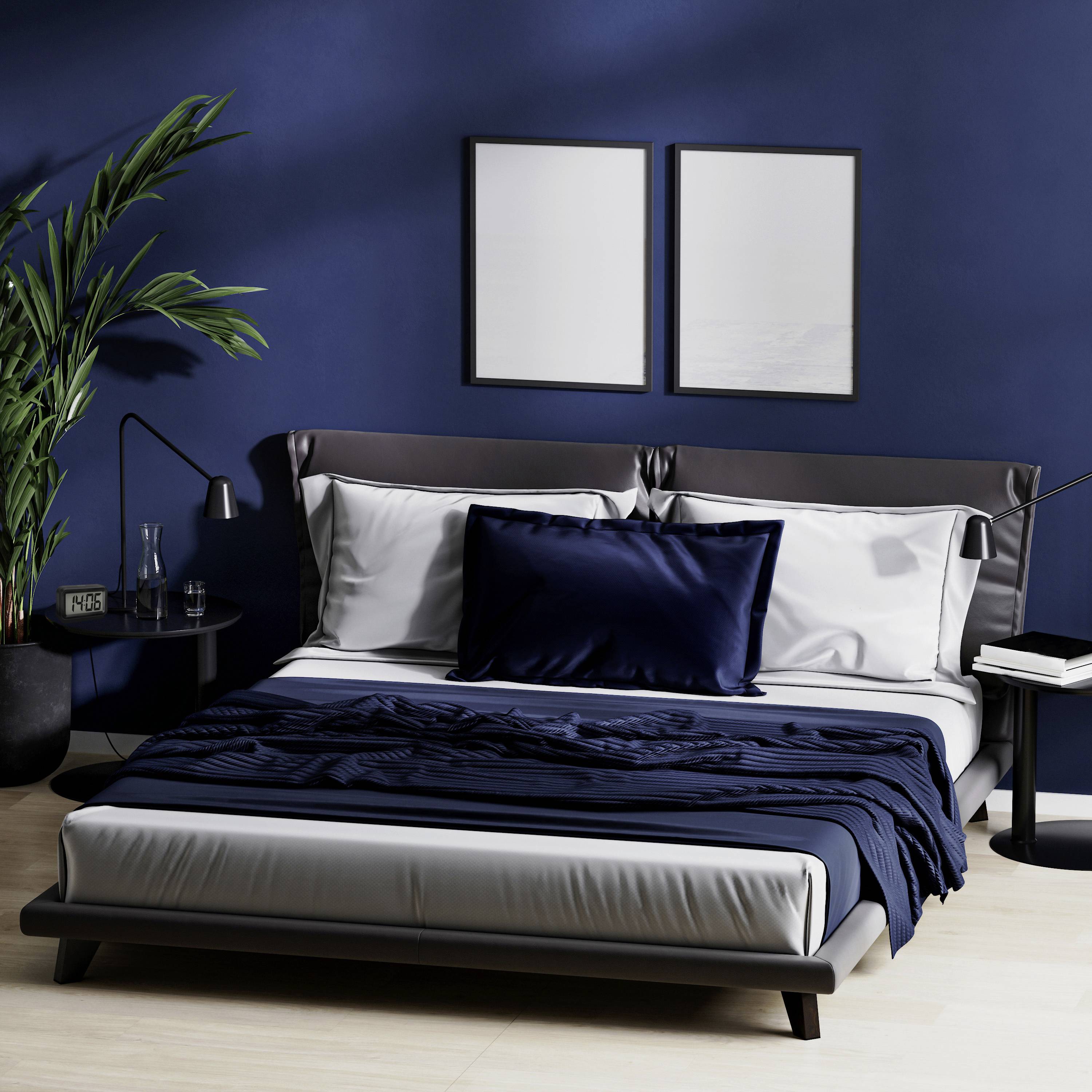 A cosy bedroom with a double bed, blue throws, two modern bedside tables with lamps and a large houseplant to the left.