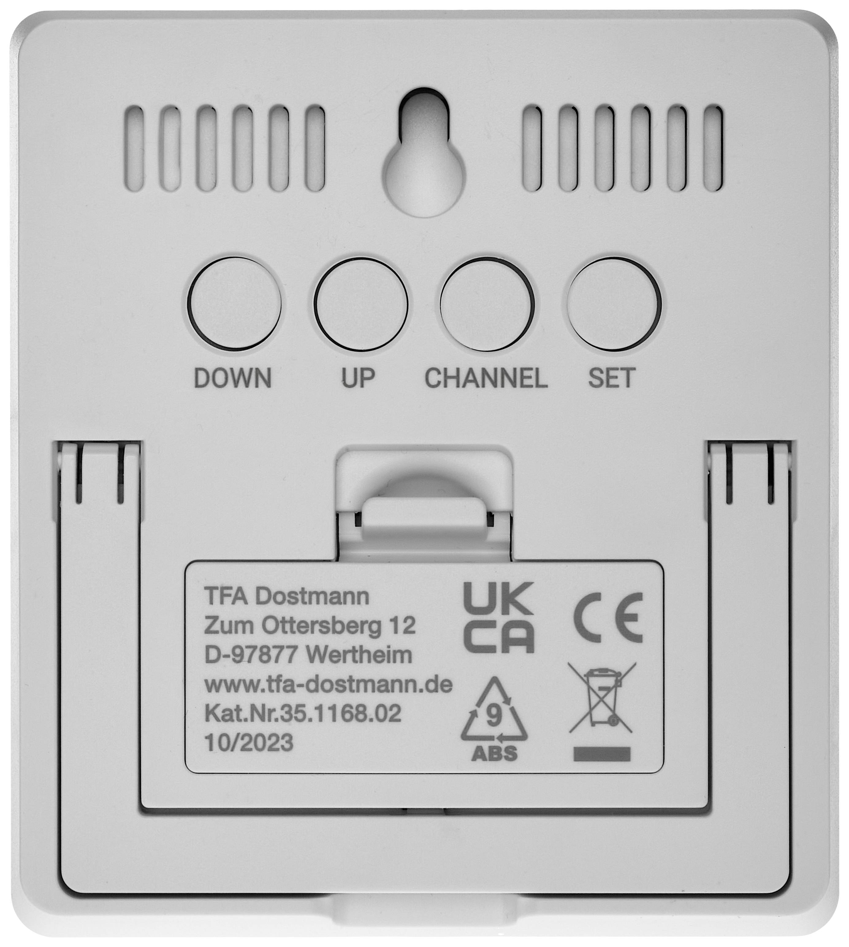 Back of an electronic remote control with the inscription 'DOWN, UP, CHANNEL, SET'. Company name and address are shown.