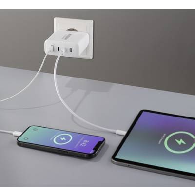 A charger with two connected smartphones displays charging icons on the screens indicating the charging process.