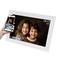 Digital photo frame displays two smiling children. Time and temperature shown in the top right corner. A hand holds a smartphone for controlling the device.