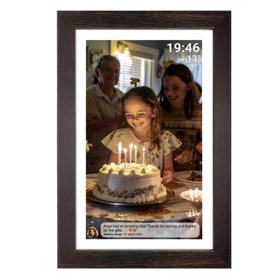 A girl smiles and looks at candles on a birthday cake, surrounded by family. Time and temperature are shown in the top right.