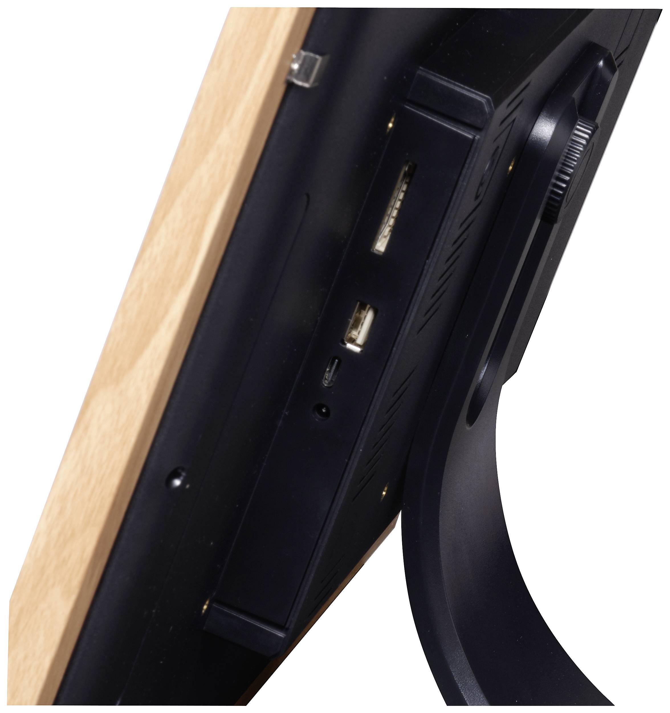 Side view of an electronic device with a wooden frame. Various connections are visible on the rear, including USB and a memory card slot.
