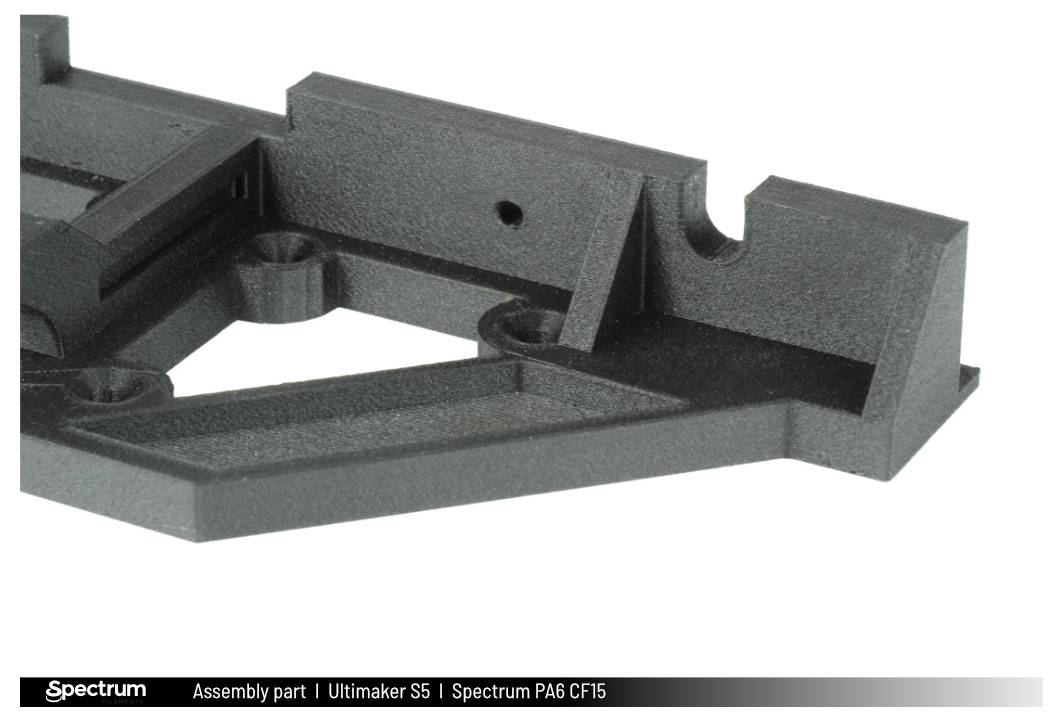 A manufacturing part for the Ultimaker S5 made from Spectrum PA6 CF15, presented on a white background.