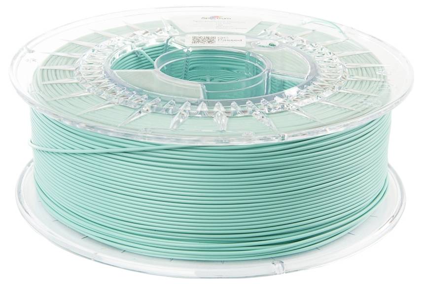 A reel of turquoise plastic filament, likely for a 3D printer, on a transparent plastic spool core.