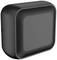 A black, square plastic object with rounded corners. The central area is recessed and smoother than the surrounding surface.