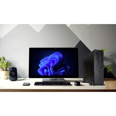 A desk with a computer, speakers, a plant and a smartphone. The monitor displays an abstract blue pattern.