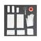 A first aid kit with bandages, scissors, adhesive tape, gloves, and gauze pads on a black background.