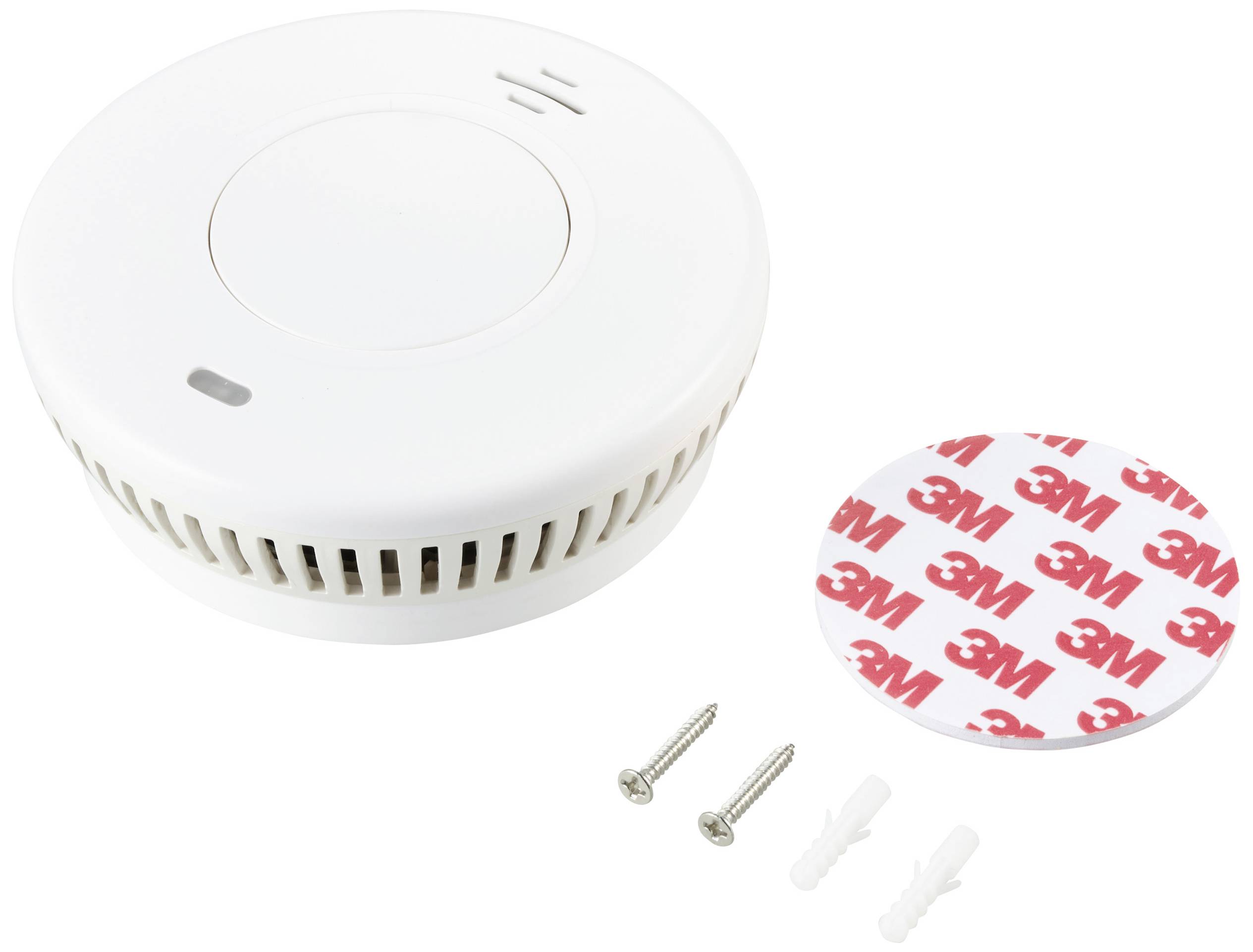 Smoke detector with mounting hardware, including two screws, two wall plugs, and a 3M adhesive strip, on a white background.