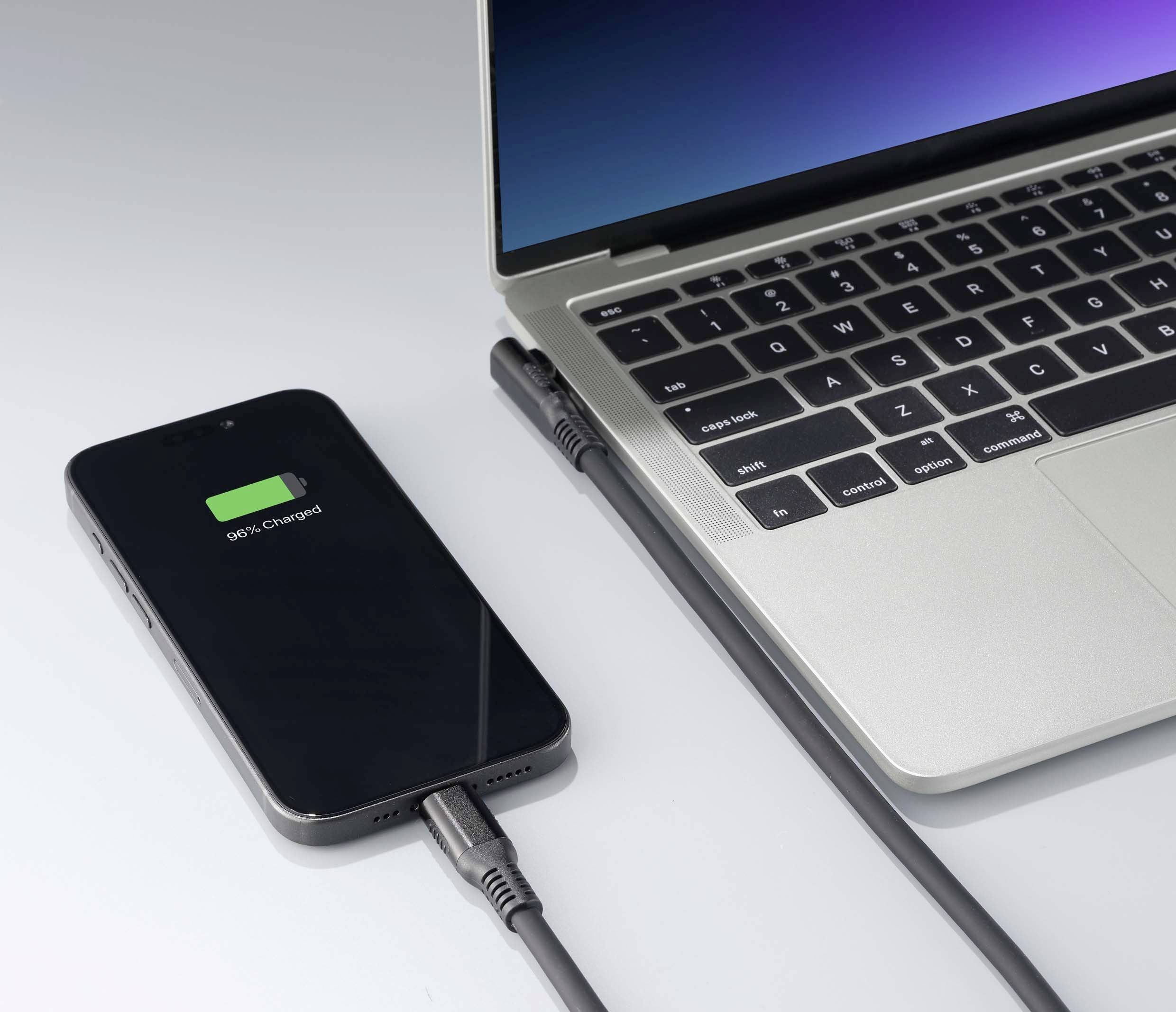 A smartphone is connected via cable to a laptop, and the screen of the smartphone displays '94% charged'.
