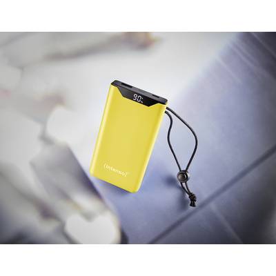 A yellow power bank with a display showing '90%' is resting on a grey surface. A black strap is attached to its side.