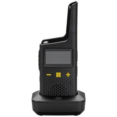 A black walkie-talkie with yellow buttons sits on a charging station. The device has a large display and a long antenna.