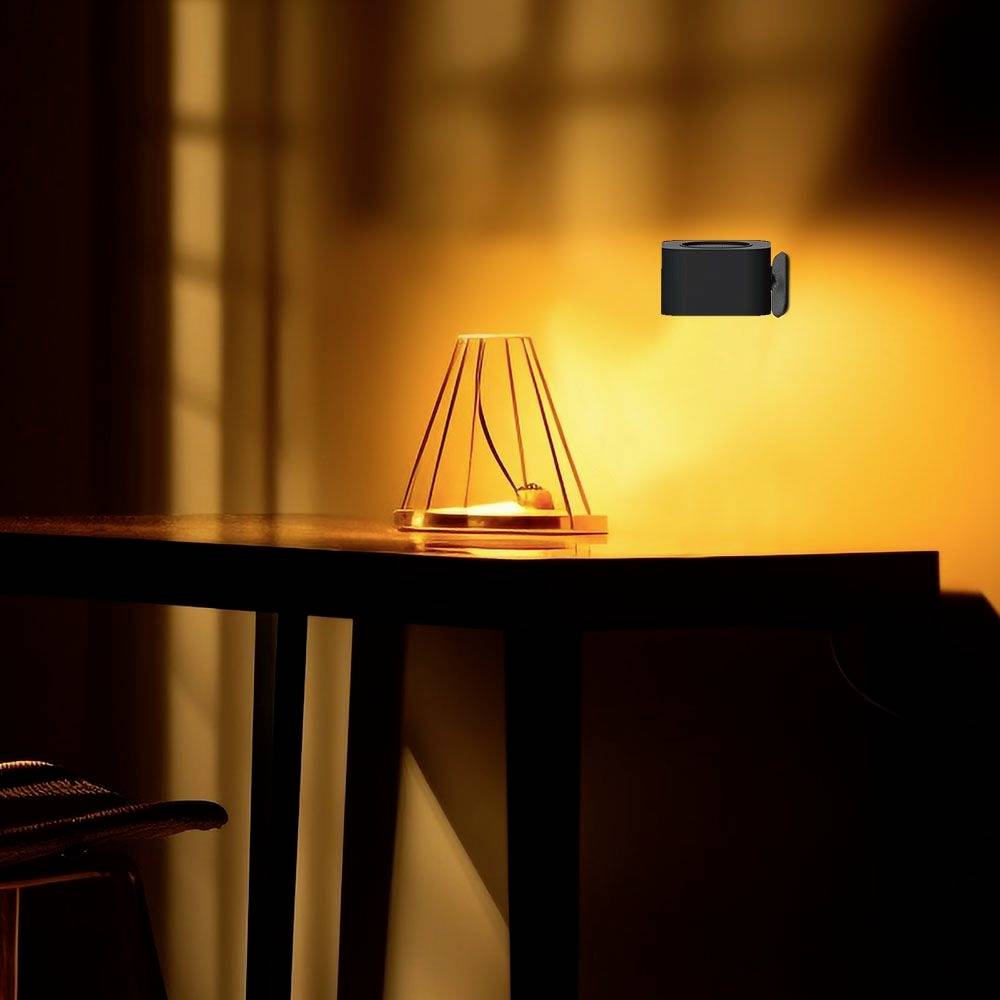 A table lamp with warm light illuminates a dark corner. In the background, a camera is mounted on the wall.