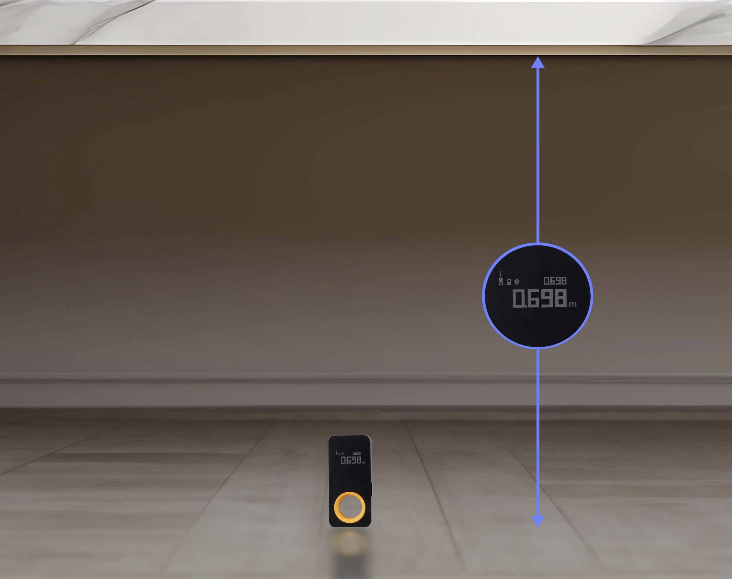 A digital measuring device indicates a height of 698 mm, positioned on a wooden floor beneath a tabletop.