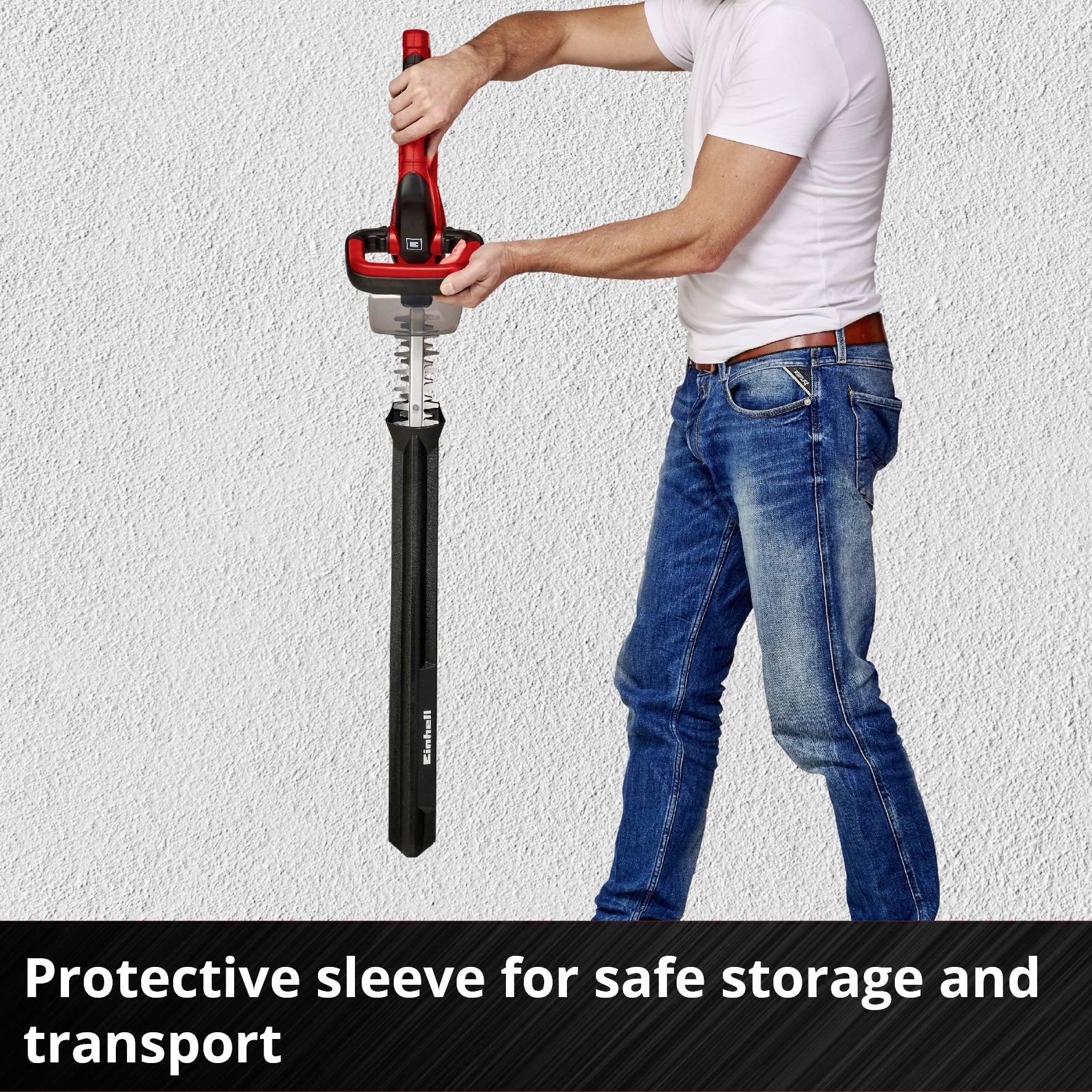 A person is using a red tool that secures and transports a long, black component.