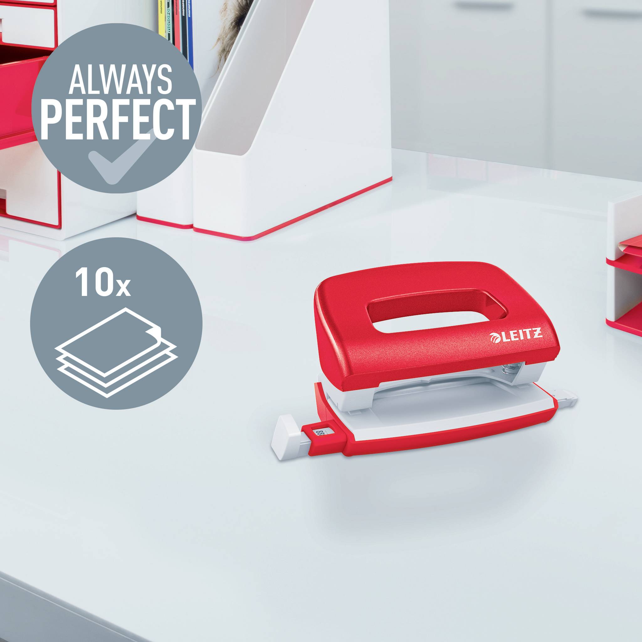 A red Leitz hole punch sits on a white table, with symbols beside it: 'Always Perfect' and '10x' indicating 10-sheet capacity.