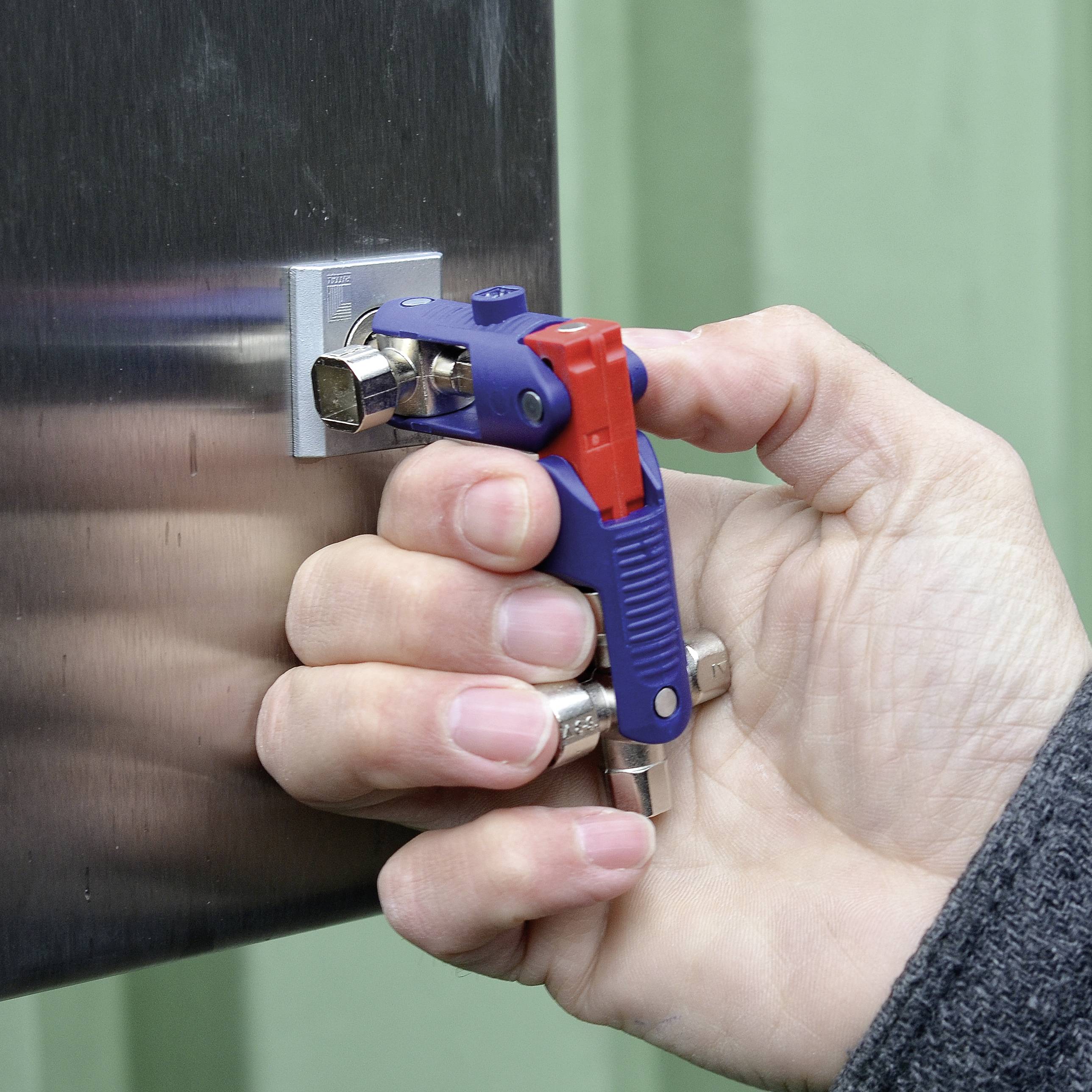 A hand is holding a blue and red square-headed key to unlock a silver box lock.