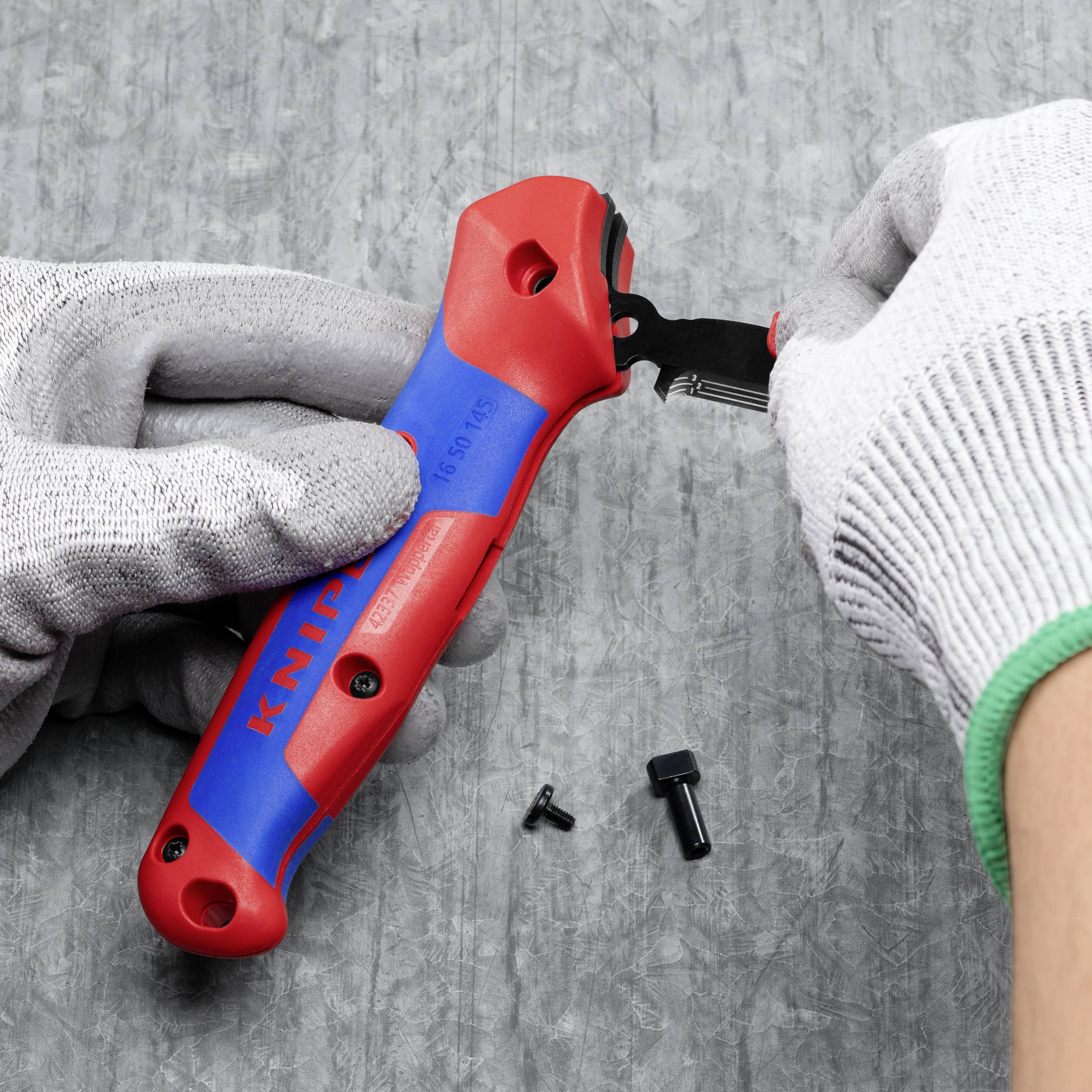 A person is repairing a tool with a screwdriver. Screws belonging to the tool are lying on the table.