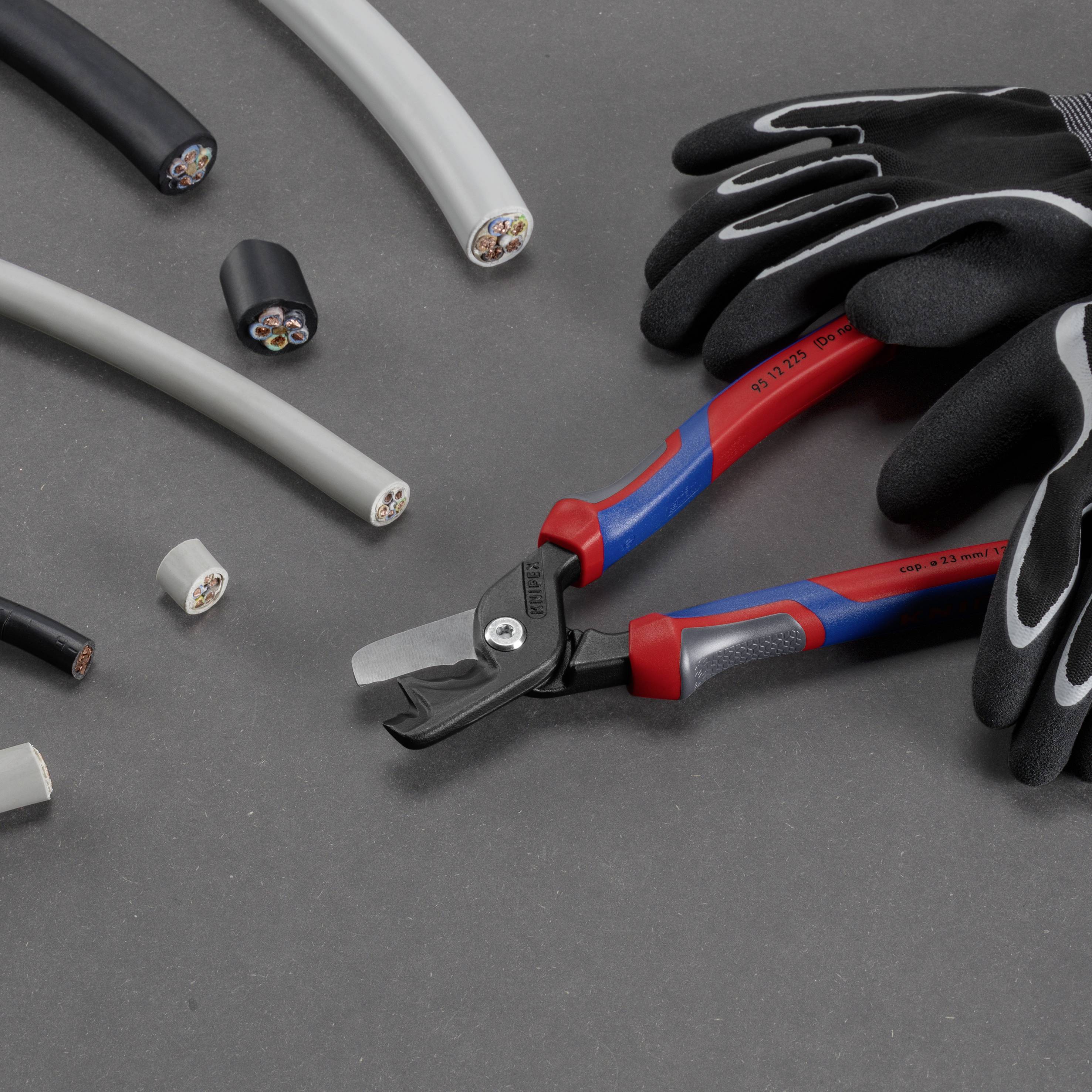 A gloved individual holds a cable cutter, surrounded by various cable types on a grey background.