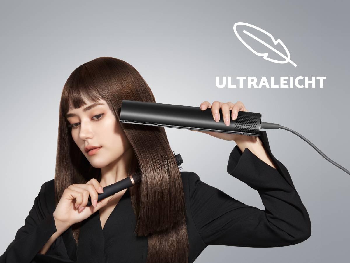 A woman smooths her long, straight hair with a hair straightener. Next to it is written 'ULTRA-LIGHT'. The background is grey.