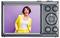 Digital camera showing a woman in a yellow suit, smiling in front of a purple background. Camera displays main control buttons.