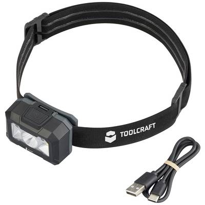 Head torch with a black band and two LEDs, marked with 'Toolcraft'. A USB charging cable lies beside it.