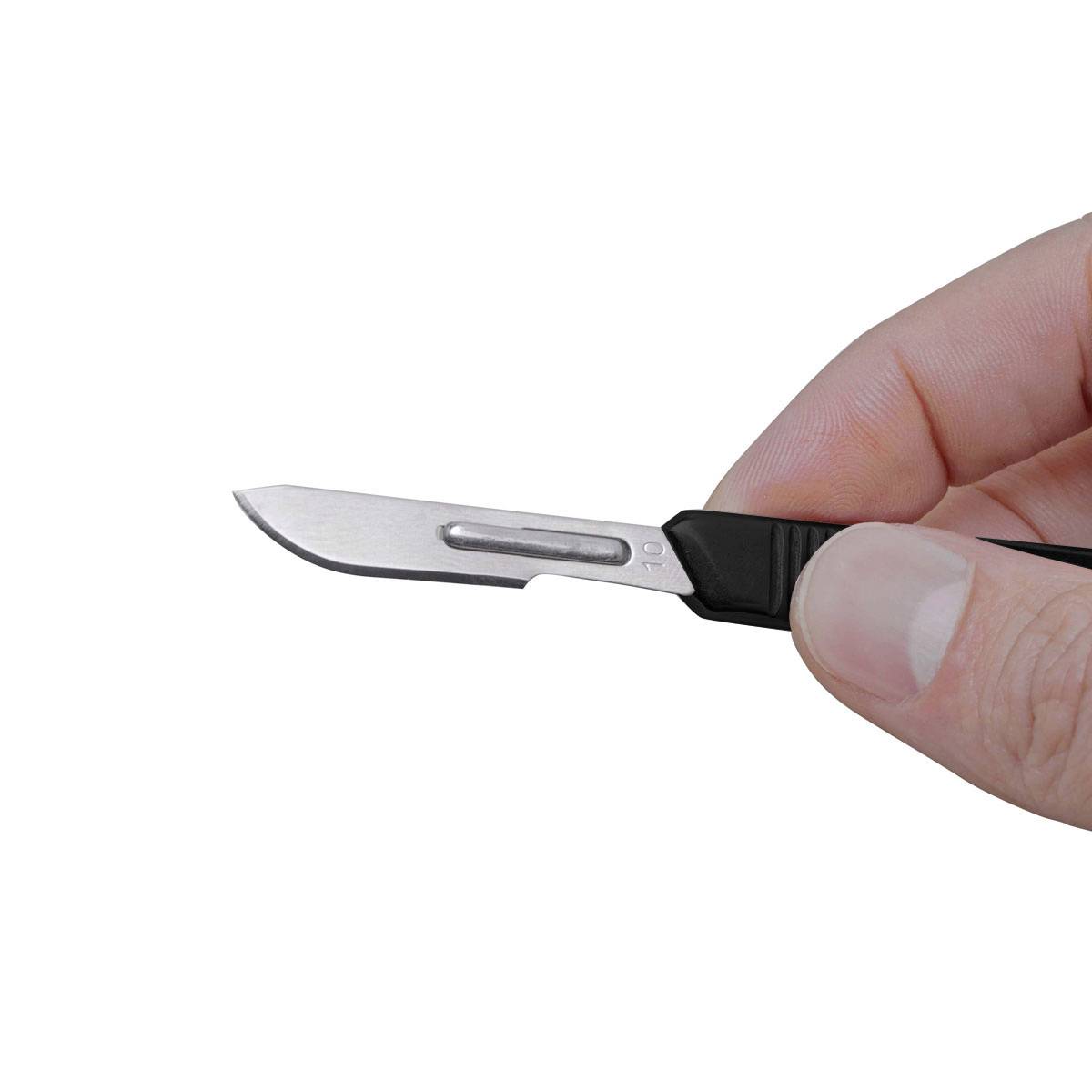 A hand is holding a surgical scalpel with a black handle and silver blade, poised to cut.