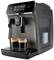 Fully automatic coffee machine with digital display, two freshly brewed espressos beneath. Device in modern stainless steel finish.