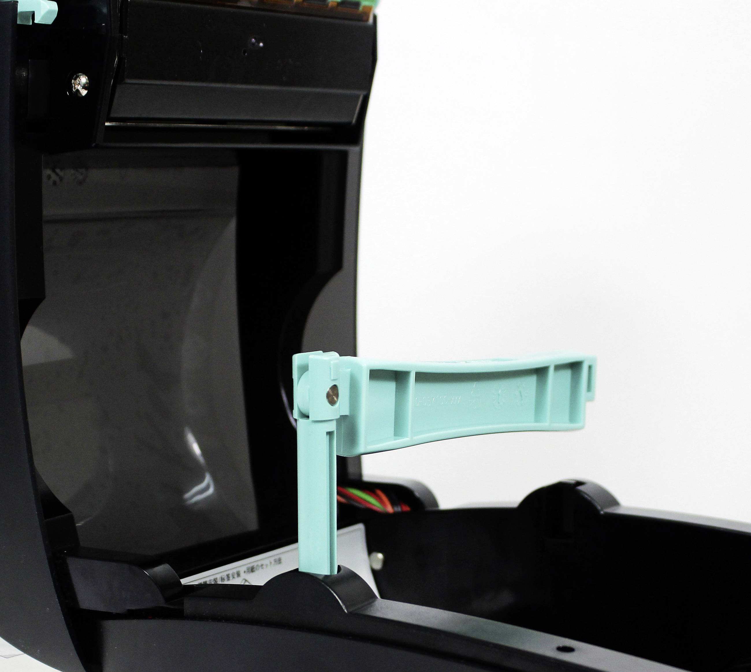 An open cash register printer with a visible blue lifting mechanism and cables inside, against a neutral background.