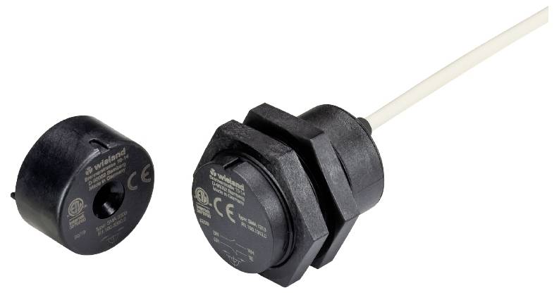 Two black network indicator devices with cables, one round, the other cylindrical, with technical information printed on them.