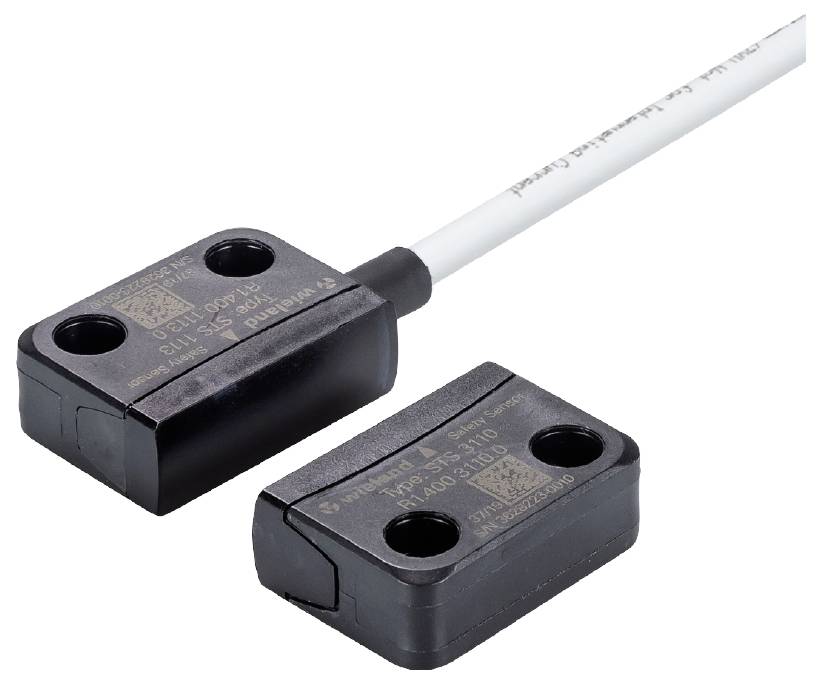 A rectangular magnetic switch with cable. Marking "S" on the top surface.