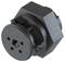 A black, hexagonal machine part with round and angular elements. It looks industrial and could be part of a larger mechanism.